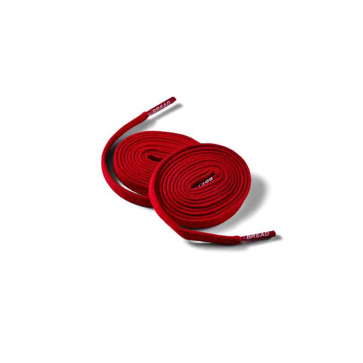 Elastic shoelace in bold red color by Bread, designed for easy slip-on and secure fit on sneakers or casual shoes.