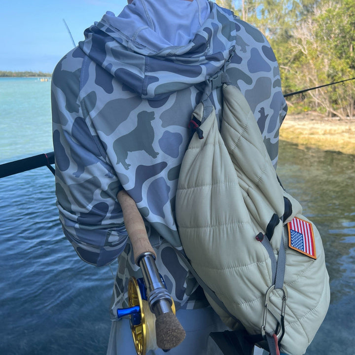 Bahama dog in Monti Coolers Loyal Companion Sun Hoodie with SPF 50, featuring camo pattern and comfortable fit.