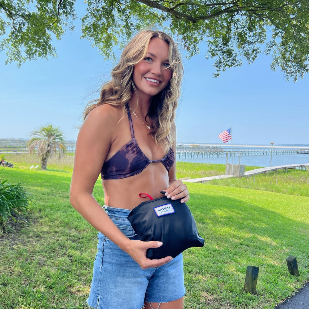 Black Monti Coolers Mayfly 14L cooler with lifestyle gear and accessories in a compact, portable design.