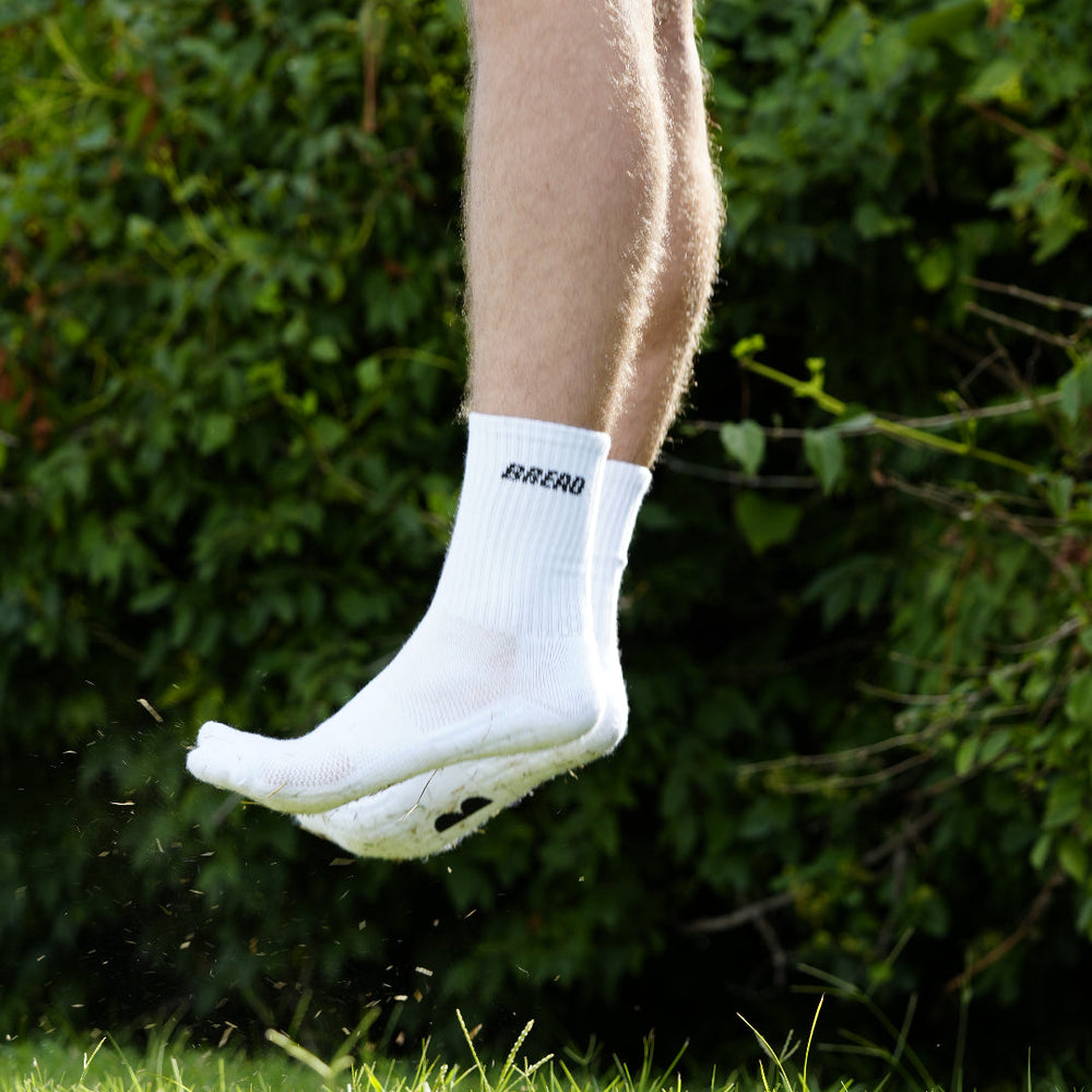 Pair of Bread Crew Socks with outdoor-inspired design, featuring colorful patterns and the Bread logo on the cuffs.