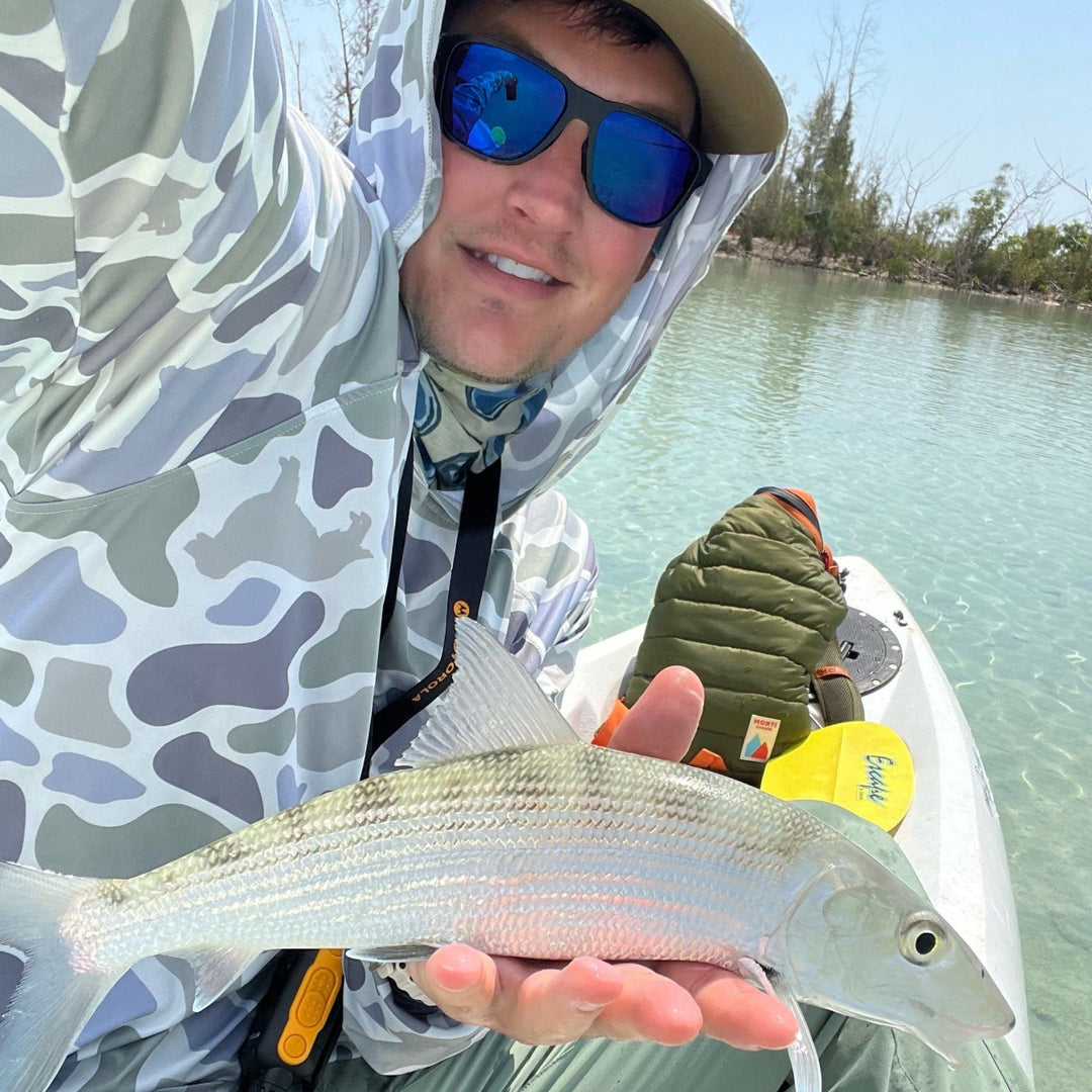 Monti Coolers Loyal Companion Sun Hoodie in camouflage with SPF 50 sun protection, featuring a comfortable hood and outdoor-ready design.