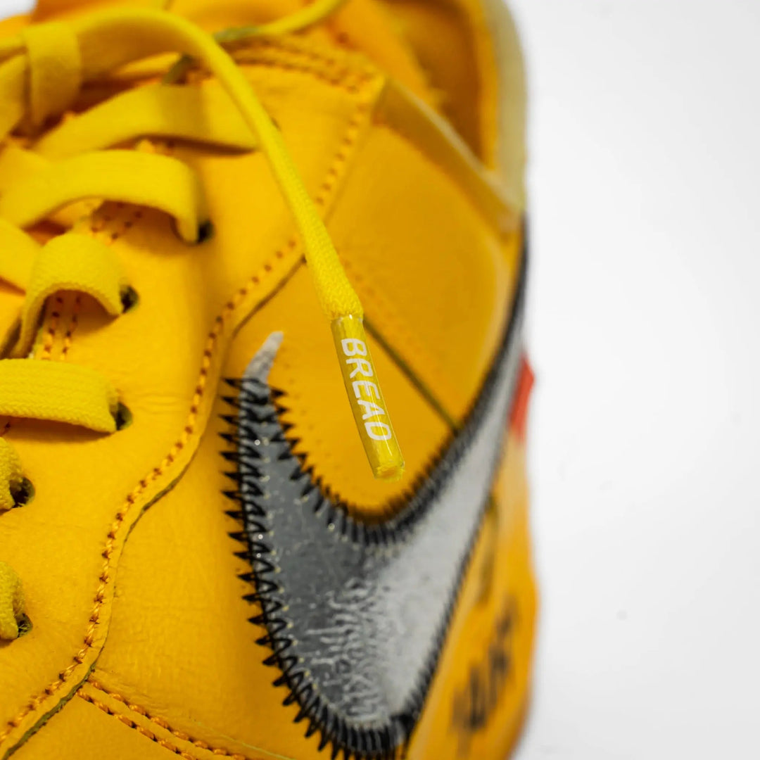 Yellow elastic shoelace from Bread's Corona series, designed for comfortable, secure fit on sneakers.