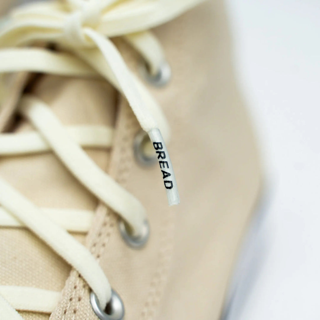 Cream elastic shoelaces from Bread Luxe Creme collection on white Converse sneakers, showcasing stretchy, stylish laces.