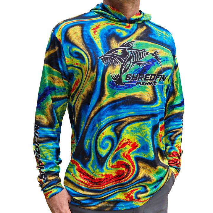 Cream ShredFin StormSurge hooded performance shirt with Sonar Swirl design, displayed on a minimalist living room setting.