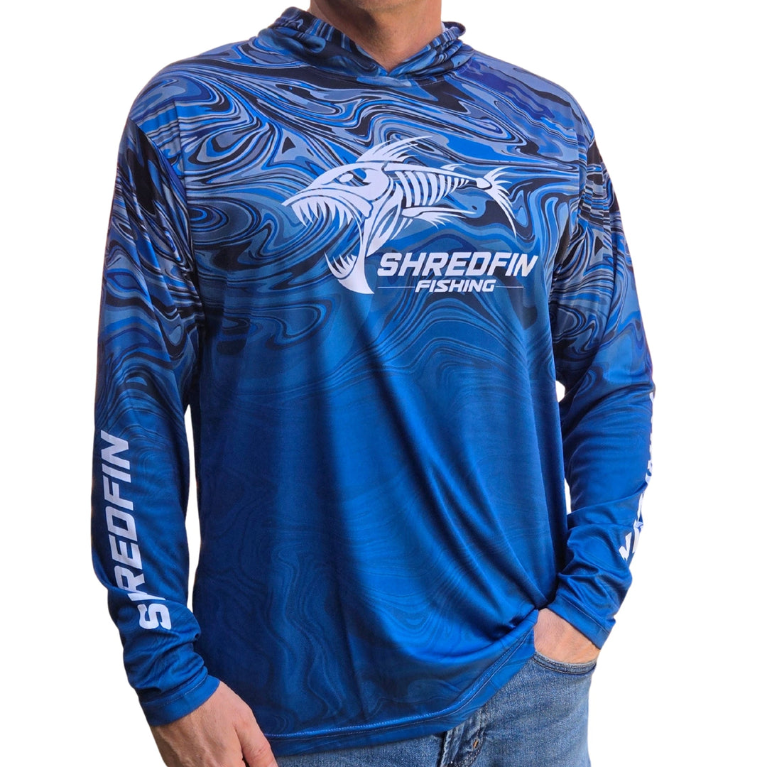 ShredFin StormSurge Hooded Performance Shirt in Blue Harbor Swirl worn outdoors after lake activity, showcasing moisture-wicking fabric.