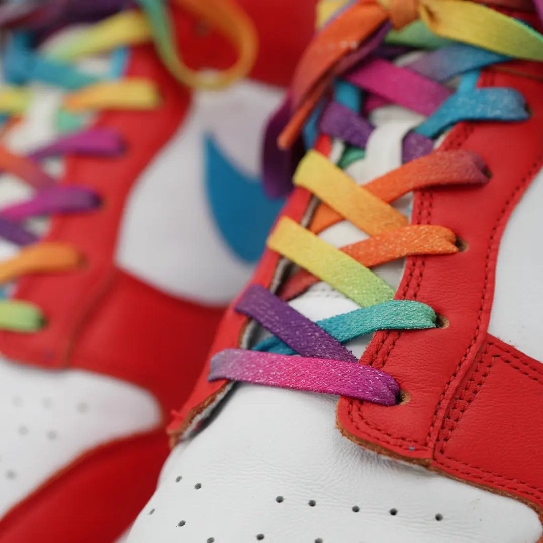 Close-up of Bread Prime Rainbow elastic shoelace with sparkly rainbow design, showcasing its vibrant, stretchy material.
