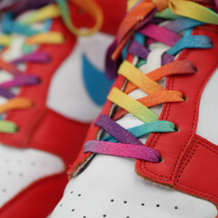 Close-up of Bread Prime Rainbow elastic shoelace with sparkly rainbow design, showcasing its vibrant, stretchy material.