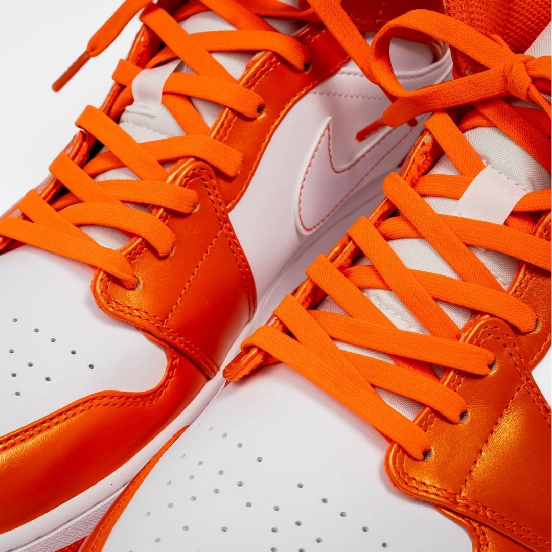 Coral orange elastic shoelace by Bread, flexible and stretchy with metal tips for easy lacing and secure fit.