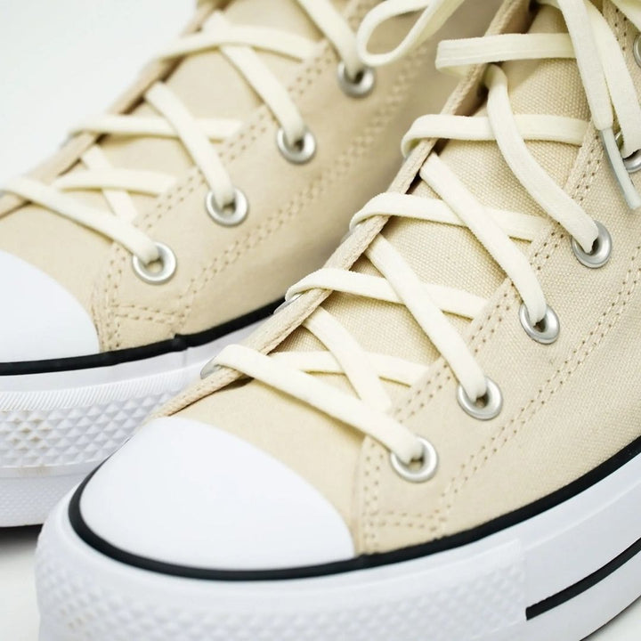 Elastic shoelace from Bread Luxe Creme collection, showcasing a sleek, flexible design in soft, cream color on a plain background.