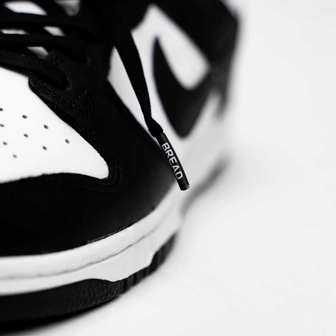 Black elastic shoelace by Bread, designed for comfortable and secure fit, shown in a close-up image of the flexible lace.
