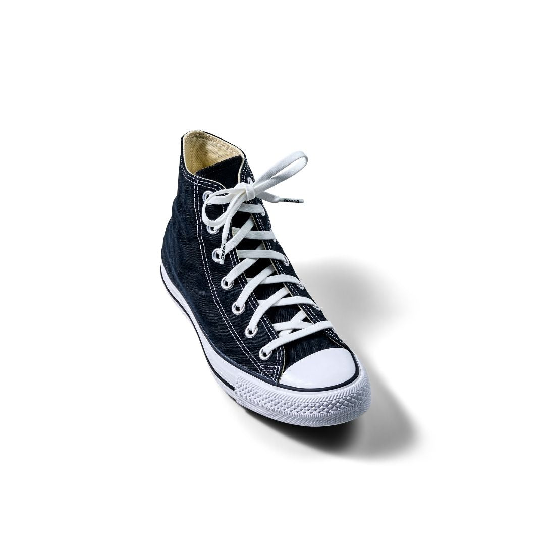 Elastic shoelace in Cloud White by Bread, showing a close-up of the flexible, stretchy laces threaded through shoe eyelets.