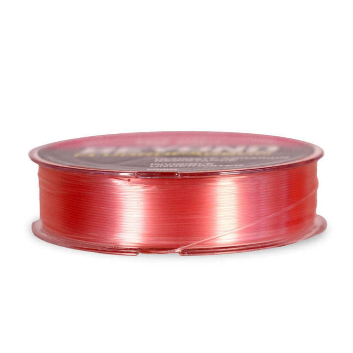 Beyond Braid fluorocarbon leader material in pink, 50 yards, showcasing the smooth, transparent fishing line on a spool.