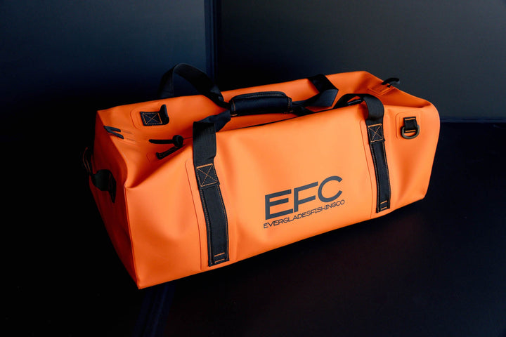 Orange BALE BAG 50L dry duffel bag by Everglades Fishing Co, showing its compact, durable design and waterproof material.