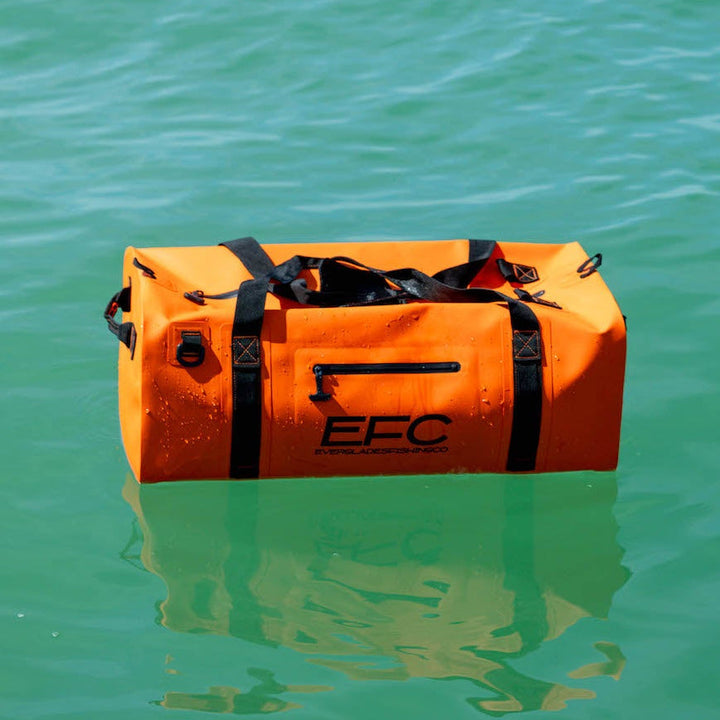 Orange BALE BAG 50L dry duffel by Everglades Fishing Co, shown with sturdy handles and waterproof material for outdoor adventures.