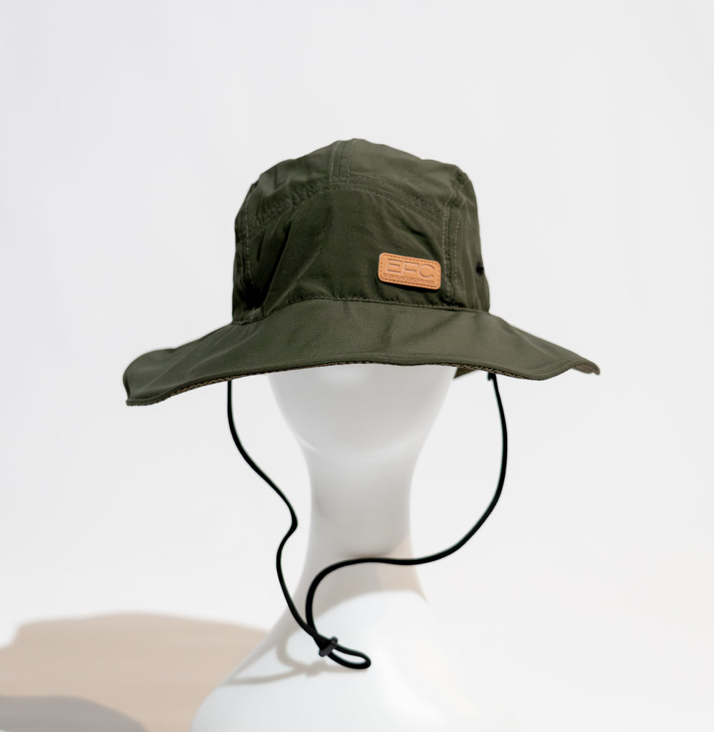 Army green bucket hat by Everglades Fishing Co, shown in a close-up image with a wide brim and casual outdoor style.