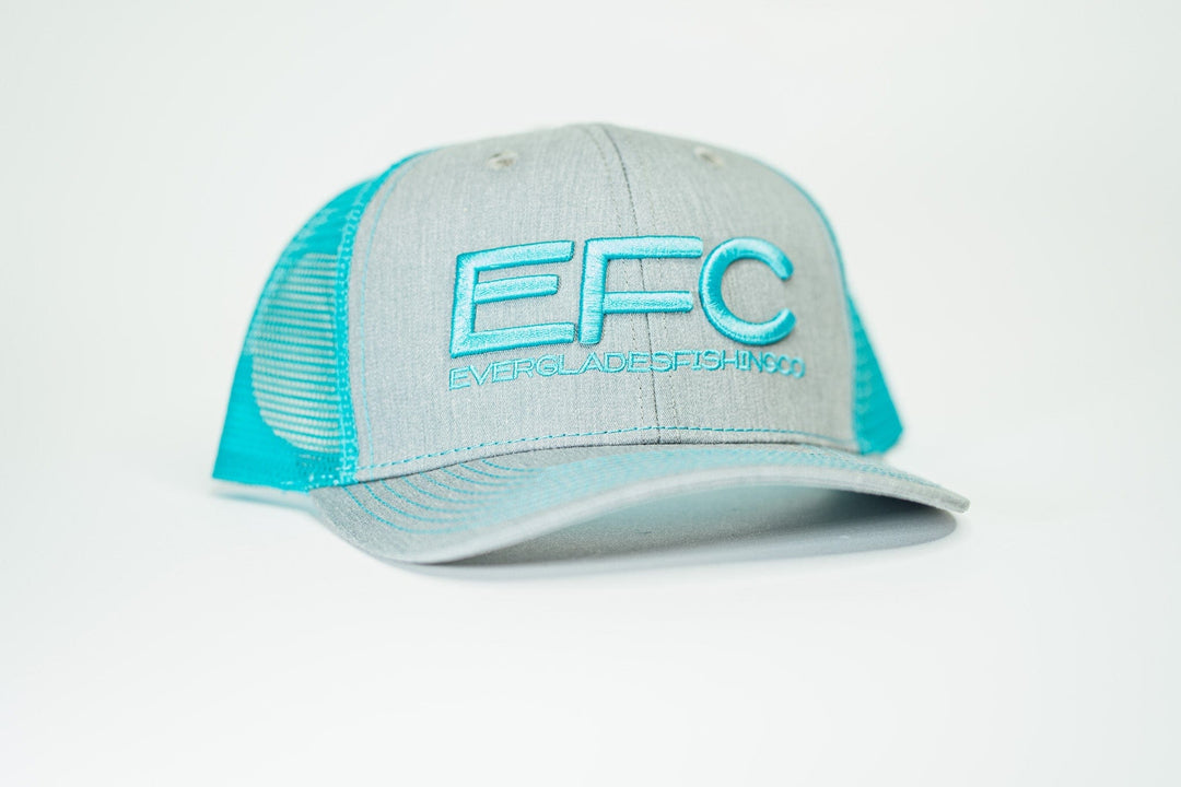 Man wearing a teal classic snapback cap by Everglades Fishing Co, showcasing the adjustable brim and embroidered logo.