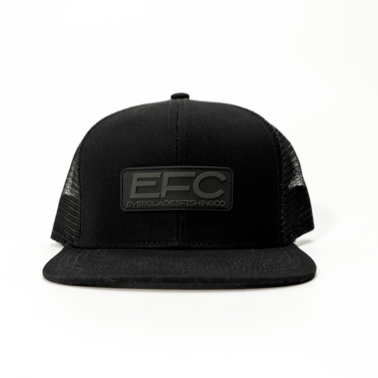 Everglades Fishing Co black snapback hat with snap closure and bold blacked-out design, front logo embroidery visible.