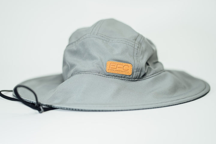 Gray bucket hat by Everglades Fishing Co, shown on a man, with a wide brim and casual style for outdoor wear.