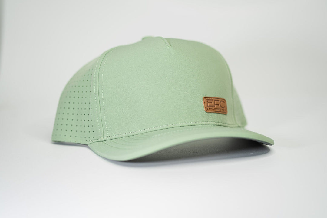 Man wearing a mint-colored picnic snapback hat by Everglades Fishing Co, showing the adjustable strap and embroidered logo.