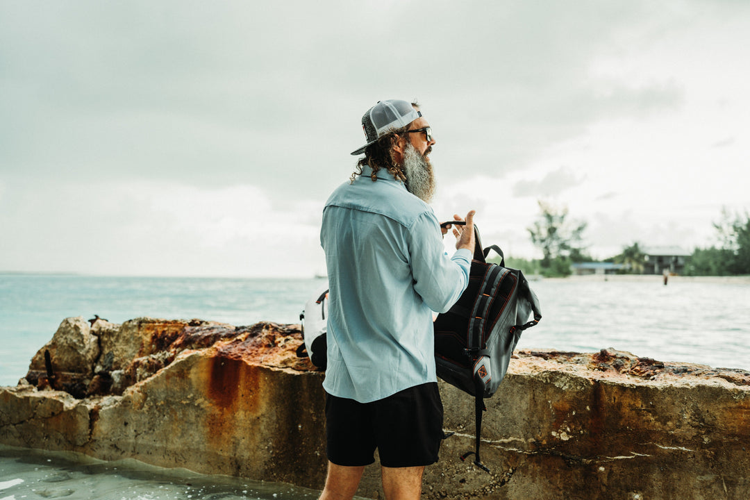 Gray 20L roll-up dry bag by Everglades Fishing Co, featuring a compact design and secure roll-top closure for waterproof storage.