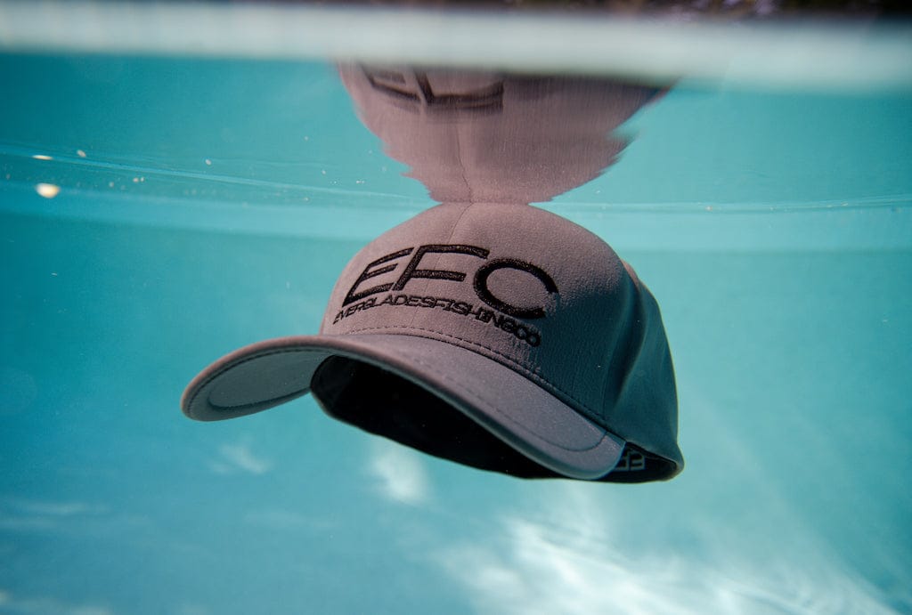 Gray performance fitted hat by Everglades Fishing Co featuring a curved brim and breathable fabric for outdoor activities.