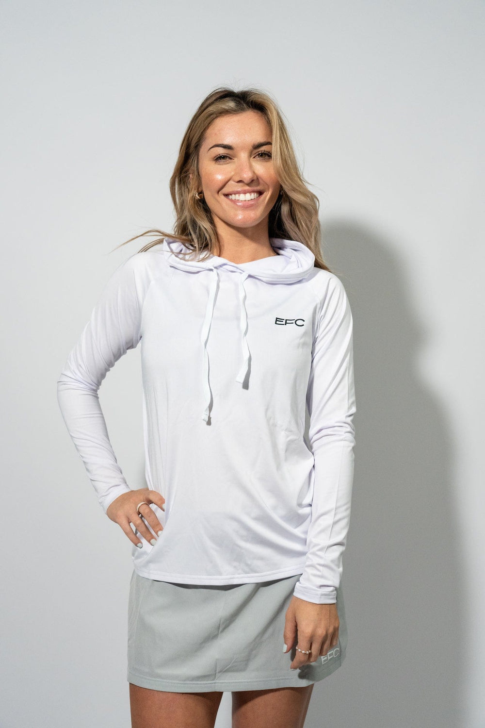 White women's performance hooded shirt by Everglades Fishing Co, designed for active outdoor fishing.