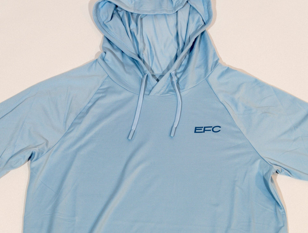 Blue Sync Women's Performance Hood shirt by Everglades Fishing Co, shown in a close-up image highlighting the fabric and fit.