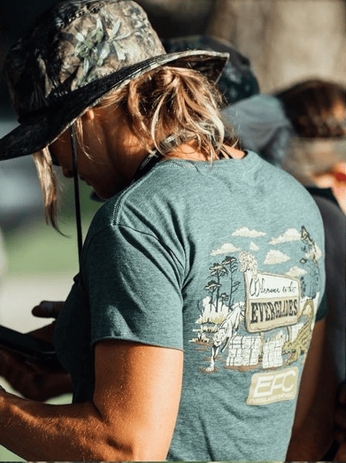 Everglades Fishing Co. Pine crop logo displayed on a screenshot from Instagram, featuring a green pine tree design.