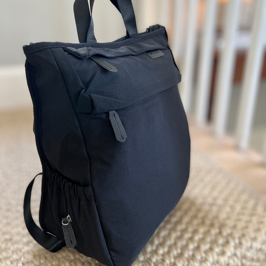 Black Monti Coolers Adventure Diaper Bag with multiple compartments and adjustable straps, designed for convenient parenting on the go.