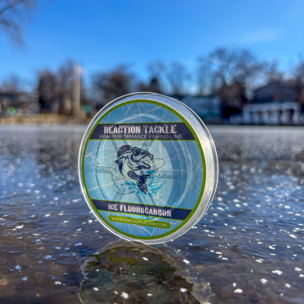 Reaction Tackle Ice Fluorocarbon Fishing Line, clear leader for fishing, shown coiled on spool with detailed packaging.
