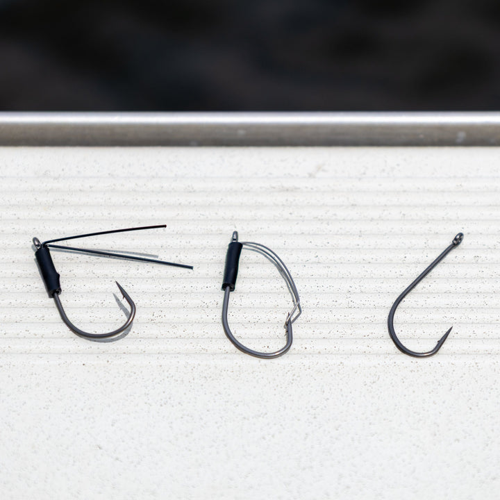 Reaction Tackle Wacky Neko Hooks, 25-pack, showing sharp fishing hooks designed for finesse fishing, arranged in a row.