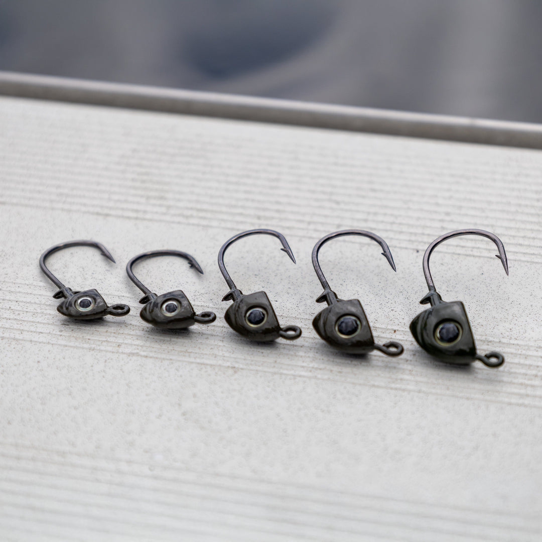 Reaction Tackle Tungsten Swimbait Jig Heads in black, 1/8 oz, 5-pack, designed for bass fishing with durable tungsten construction.