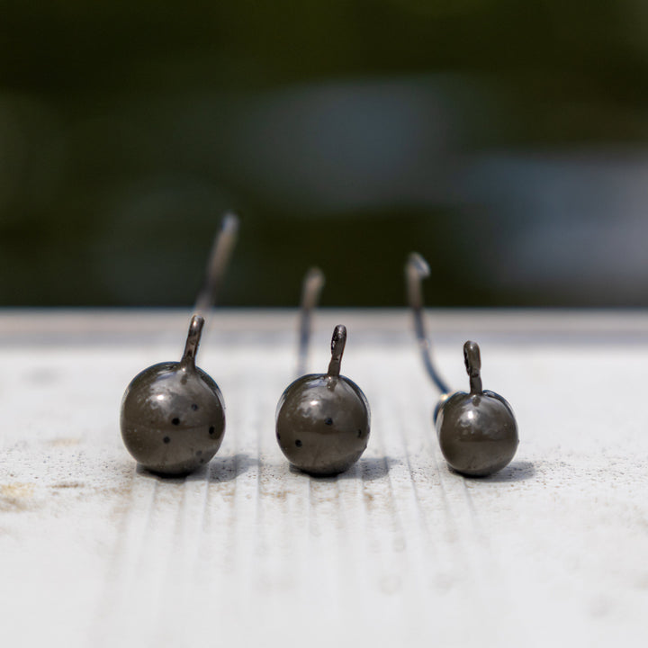 Reaction Tackle Tungsten Screw Lock Jig Heads in a 5-pack, featuring durable design and screw lock hooks for fishing.