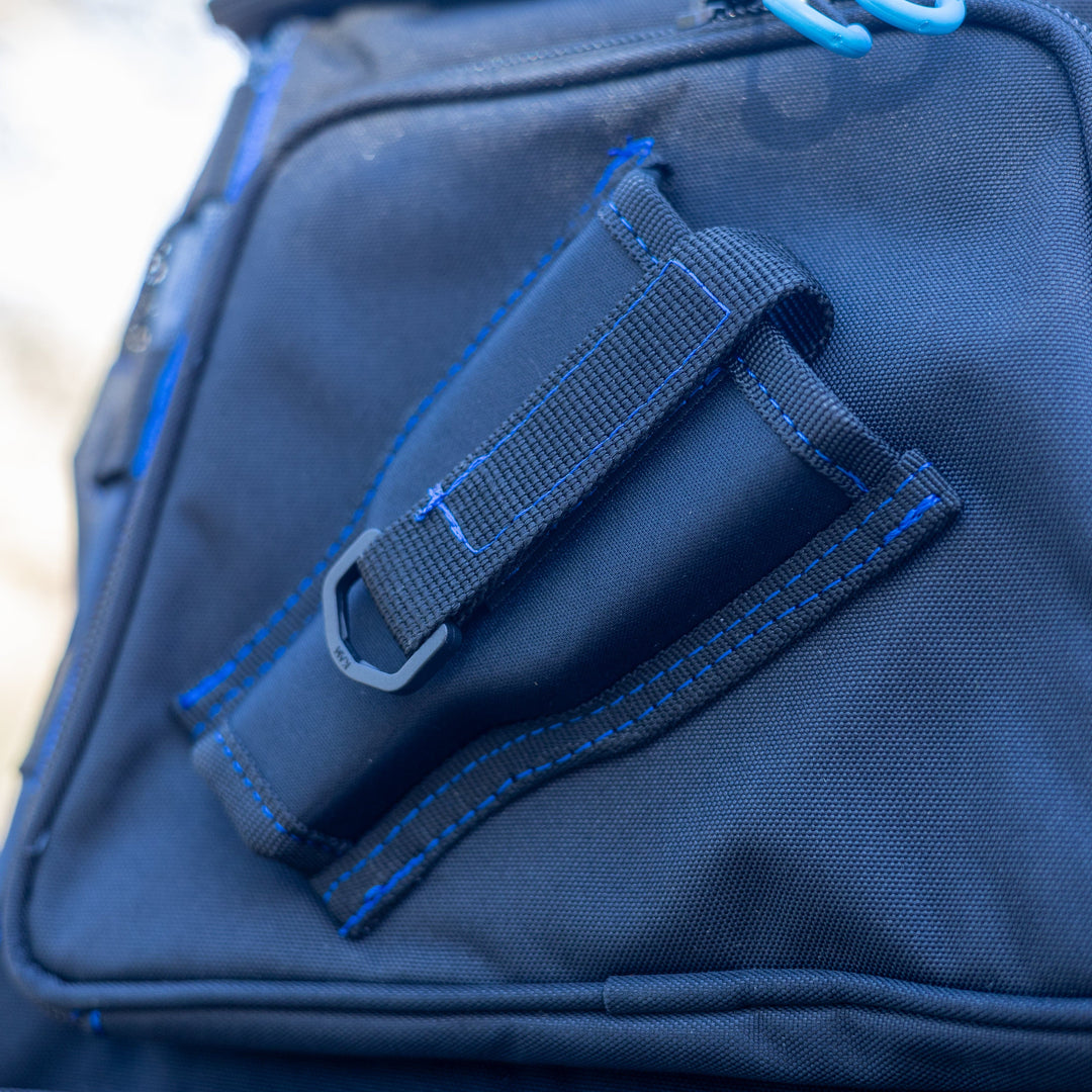 Reaction Tackle fishing tackle backpack with trays included, featuring multiple compartments and durable straps for outdoor fishing trips.