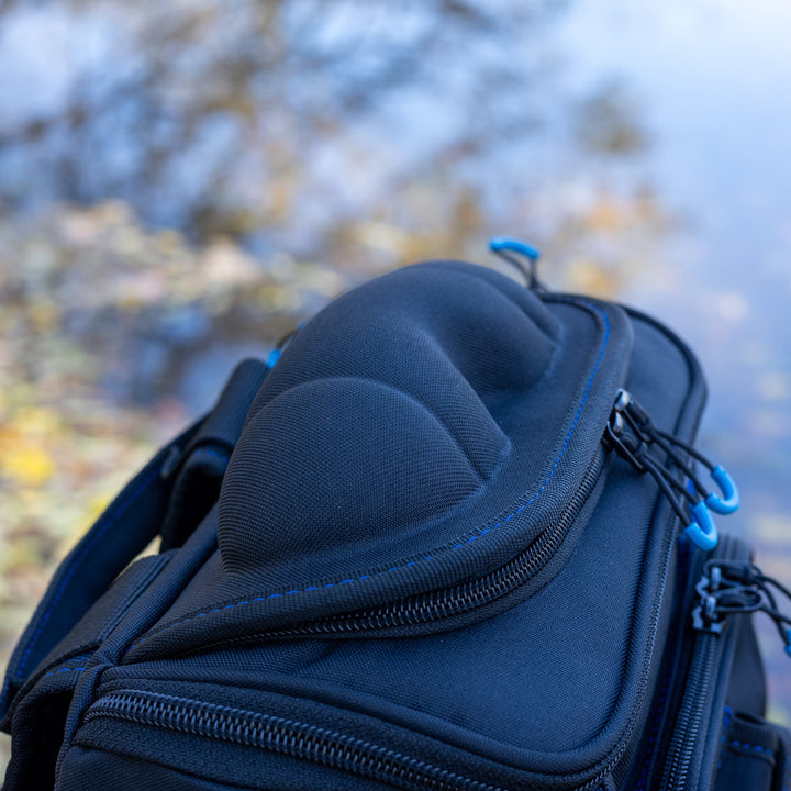 Reaction Tackle fishing tackle backpack with multiple storage trays, designed for anglers to organize fishing gear efficiently.