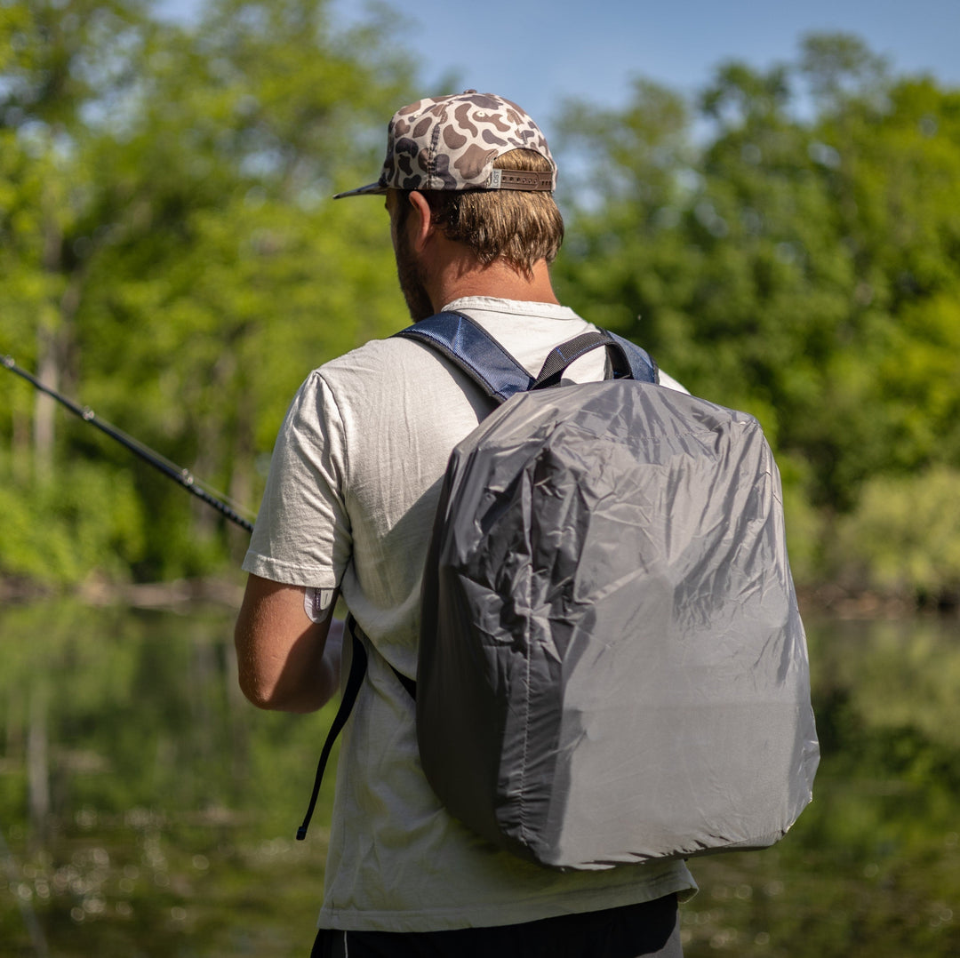 Reaction Tackle fishing tackle backpack with trays included, showing multiple compartments and adjustable straps for fishing gear storage.