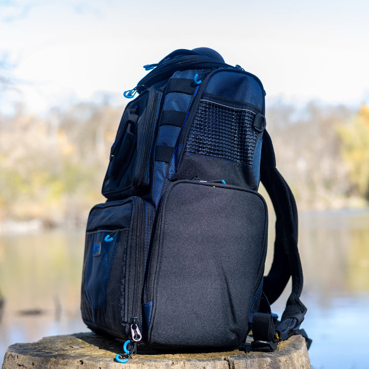 Reaction Tackle fishing tackle backpack with multiple compartments and trays for organized fishing gear storage.