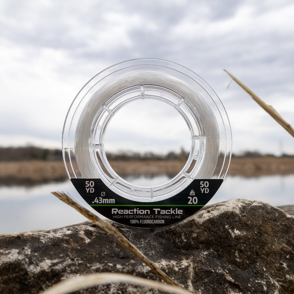 Reaction Tackle 100% Pure Fluorocarbon Fishing Line in clear, 4lb test, 50 yards, displayed coiled on a fishing reel