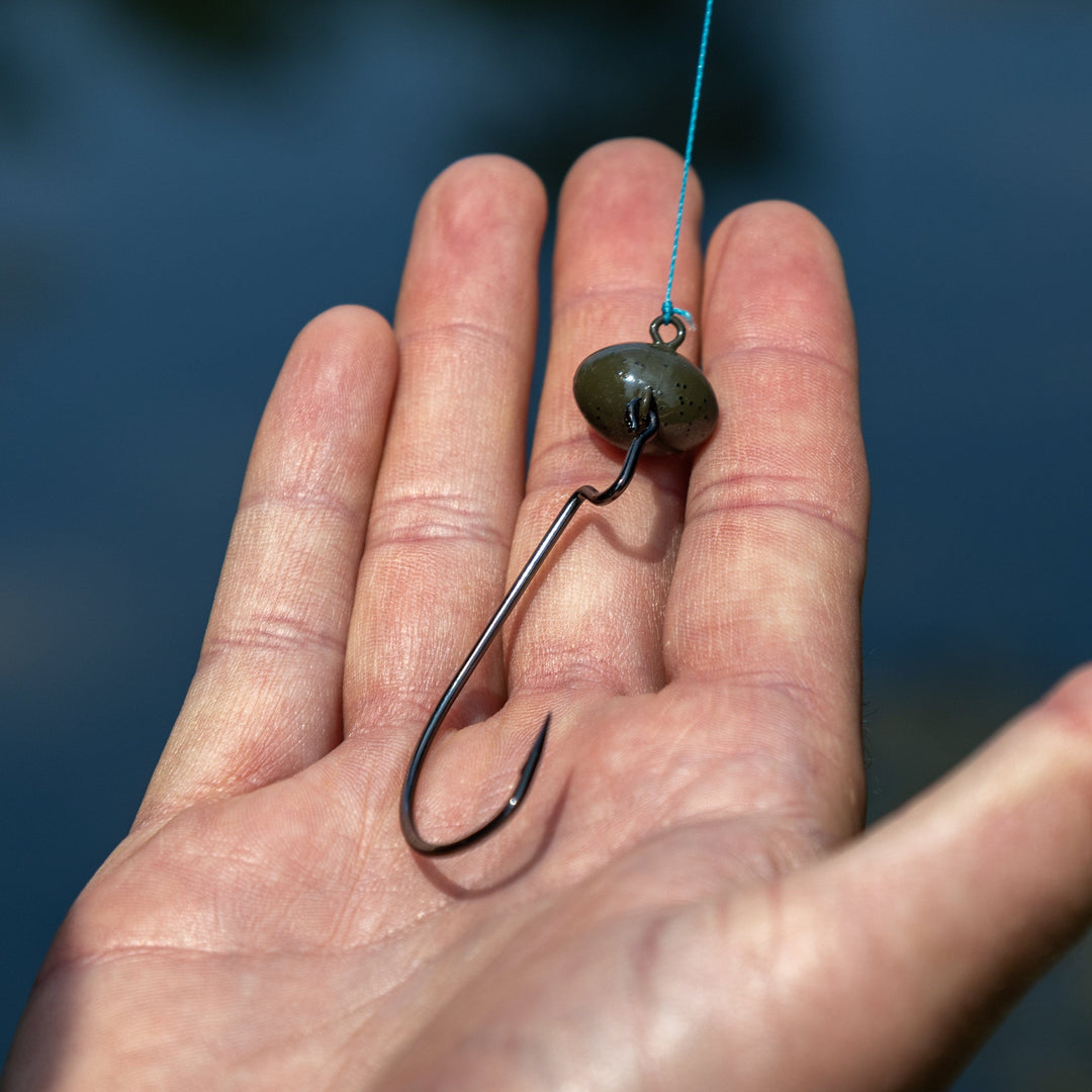 Reaction Tackle Tungsten Football and Swing Jig Heads, 3-pack, with detailed hooks and shiny tungsten finish for fishing.