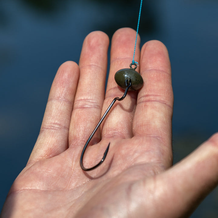 Reaction Tackle Tungsten Football and Swing Jig Heads, 3-pack, with detailed hooks and shiny tungsten finish for fishing.