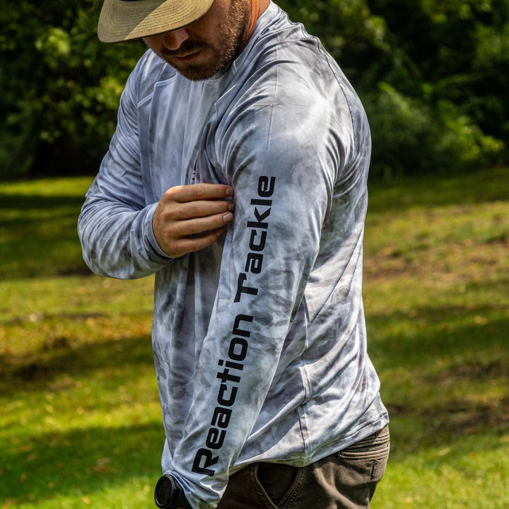 Gray Reaction Tackle SPF 50+ long sleeve fishing shirt with UPF protection, designed for sun safety and comfort during outdoor fishing.