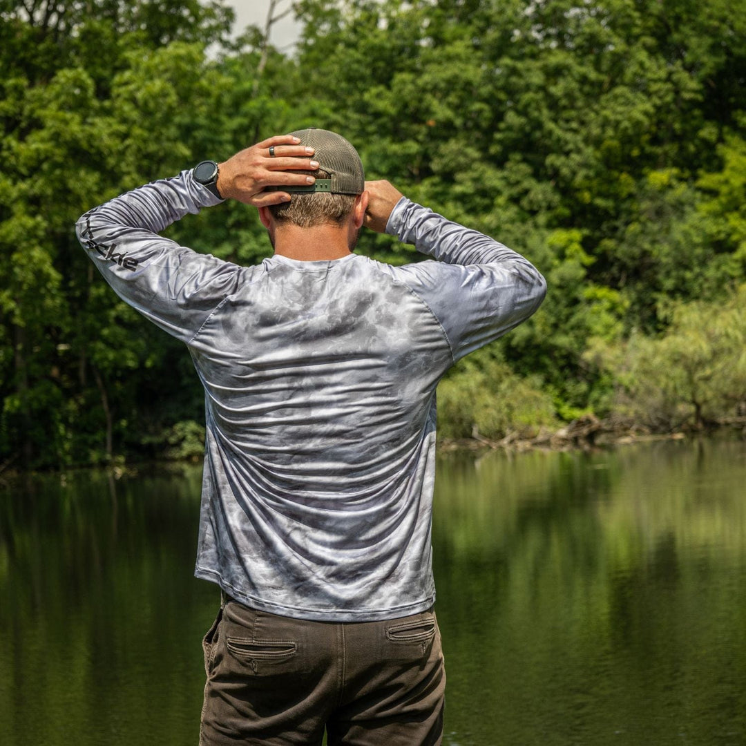 Gray Reaction Tackle SPF 50+ long sleeve fishing shirt with UPF protection, designed for sun protection and comfort during outdoor fishing.