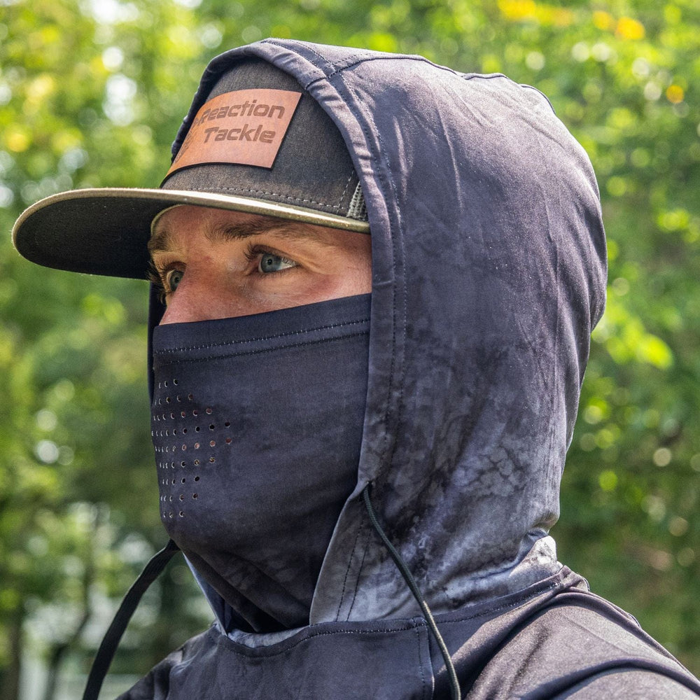 Reaction Tackle SPF 50+ long sleeve fishing shirt with hood and gaiter in black, designed for sun protection and outdoor fishing.