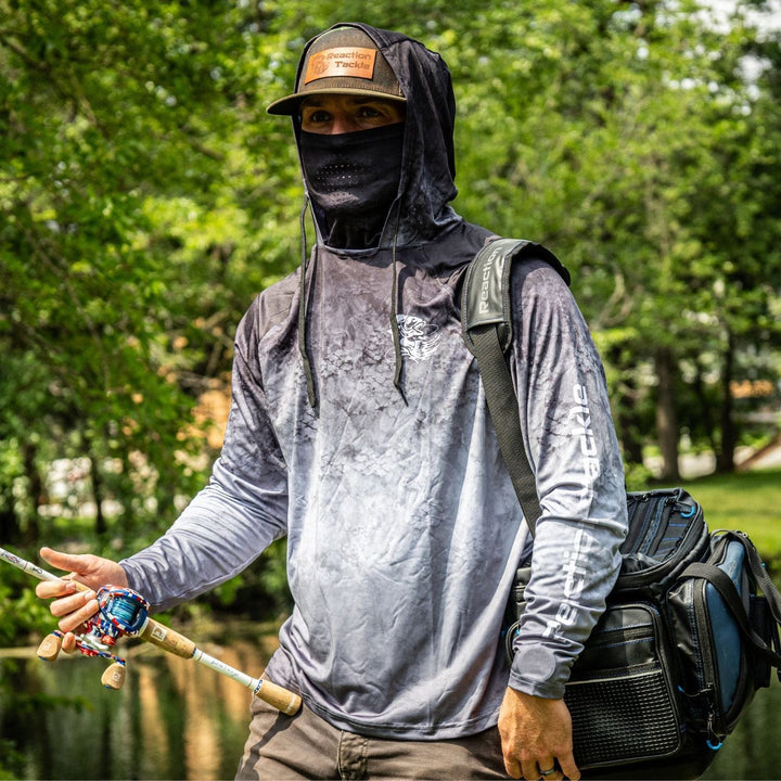 Black Reaction Tackle SPF 50+ long sleeve fishing shirt with hood and gaiter, designed for sun protection during outdoor activities.