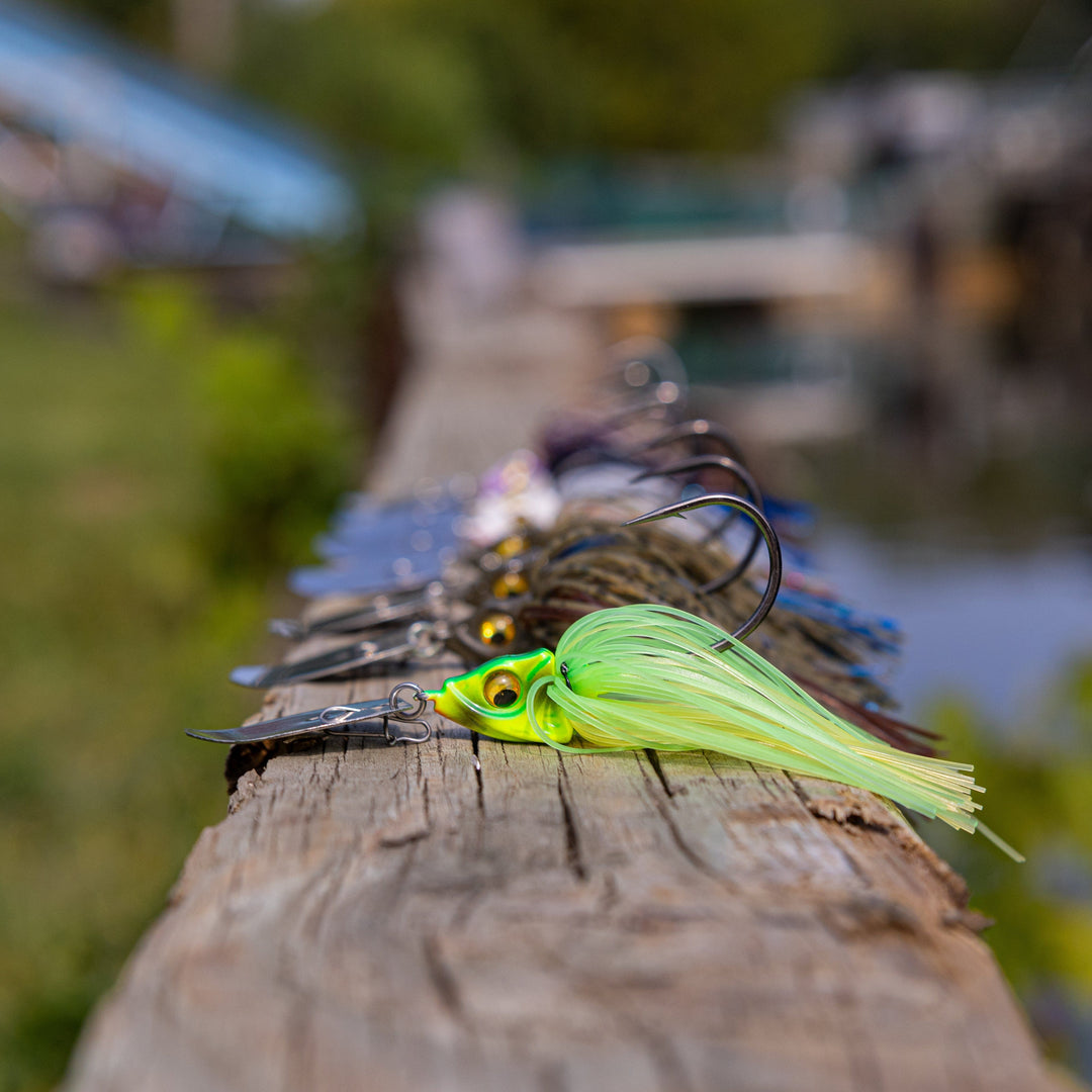 Reaction Tackle Tungsten Vibrating Bladed Swim Jigs 2-pack, showcasing detailed metal blades and fishing jig hooks for bass fishing.