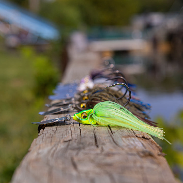 Reaction Tackle Tungsten Vibrating Bladed Swim Jigs 2-pack, showcasing detailed metal blades and fishing jig hooks for bass fishing.
