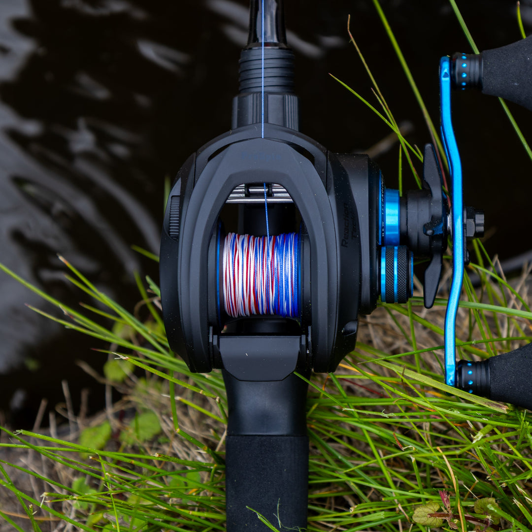 Reaction Tackle ProSpin baitcasting fishing reel with 6.8:1 gear ratio, black and silver finish, featuring spool and handle components.