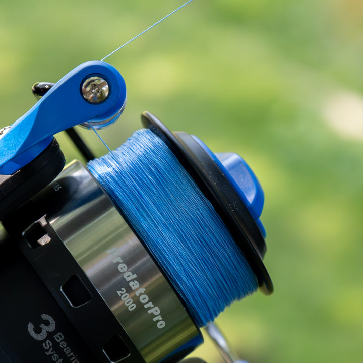 Reaction Tackle braided fishing line, 5X, made in the USA, showing the spool with tightly wound braided line and brand label.