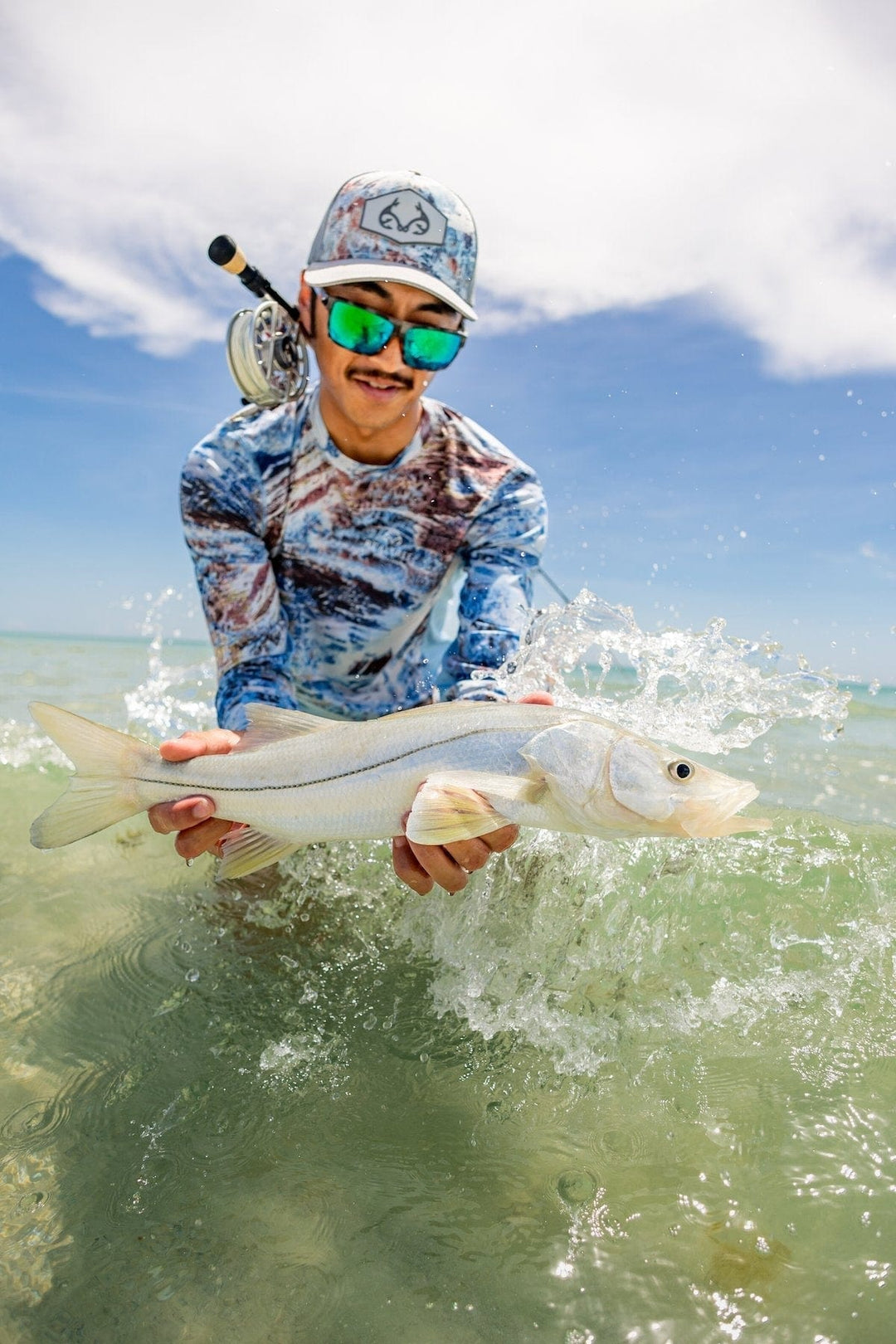 RedFin Polarized Hatteras fishing sunglasses with black frames and polarized lenses, designed for outdoor and fishing activities.