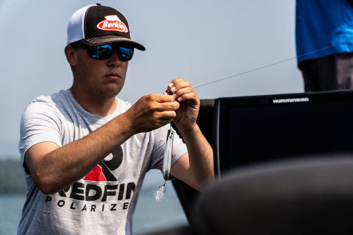 RedFin Polarized Outer Banks fishing sunglasses with matte honey drift frame and amber-green polarized lenses.
